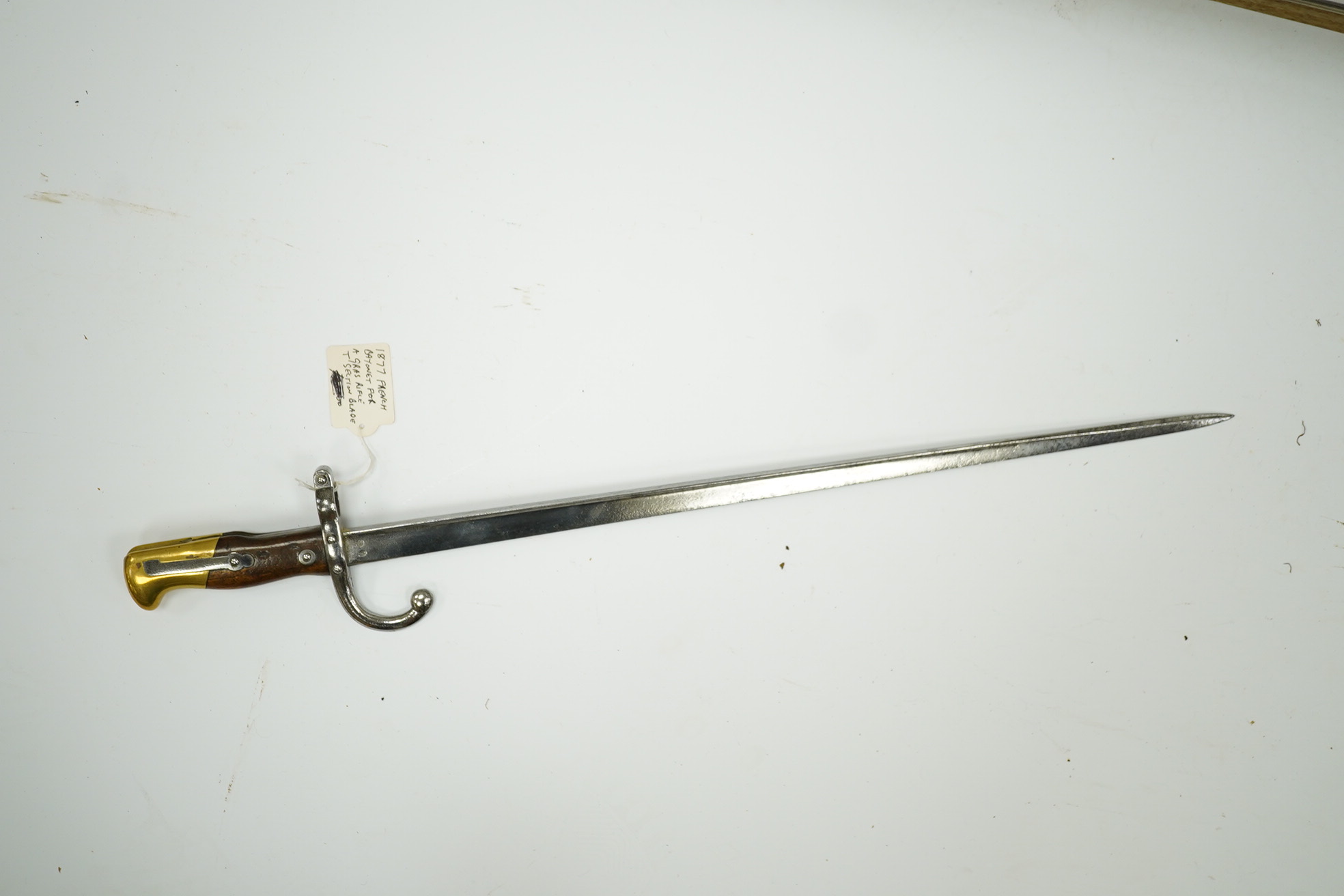 Two French Gras bayonets; a bayonet with a T-section blade dated 1877, and another almost identical blade dated 1879, scabbards missing. Condition - good